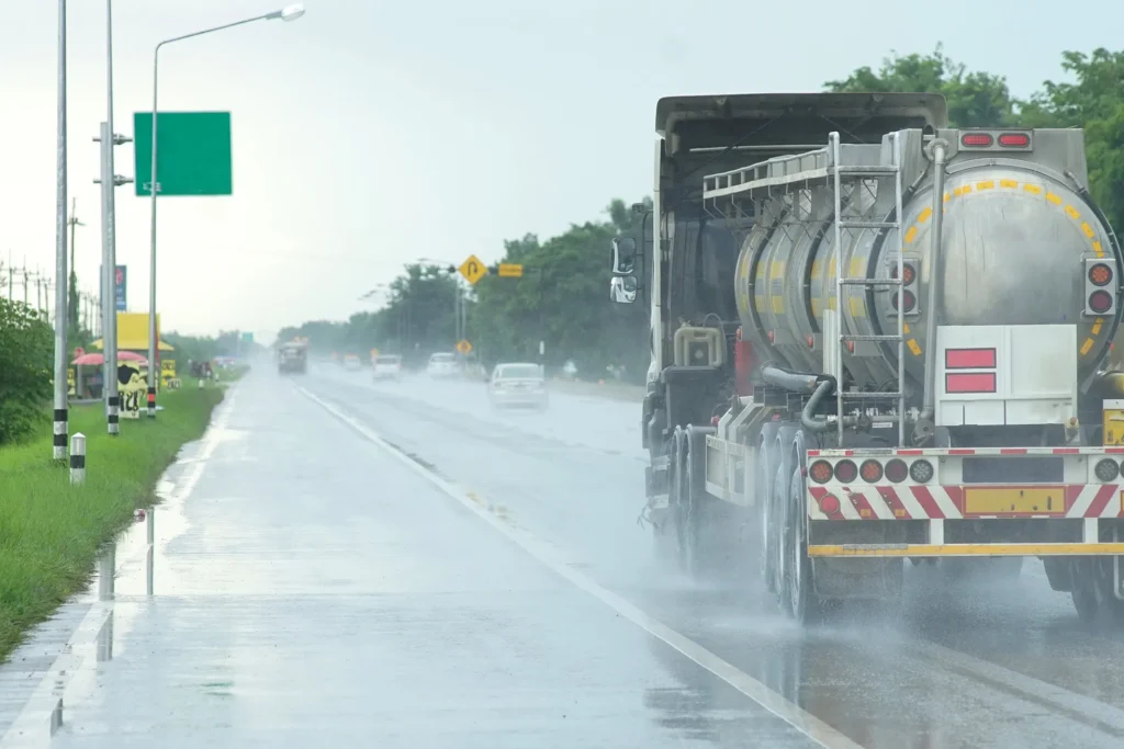 A tanker truck driving down the road.