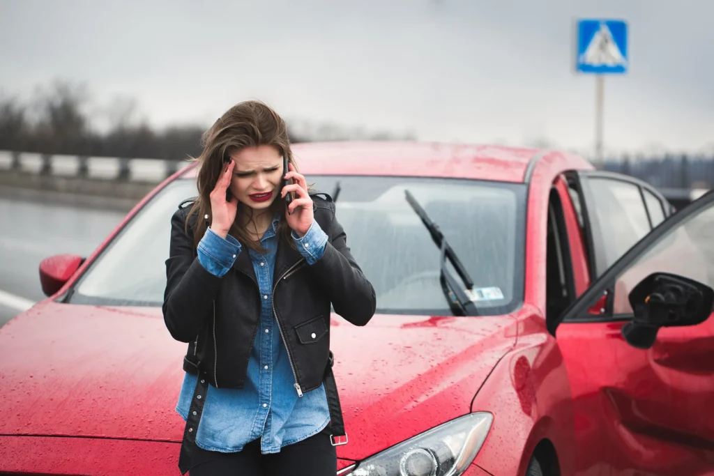 A woman calling her lawyer after a car accident.