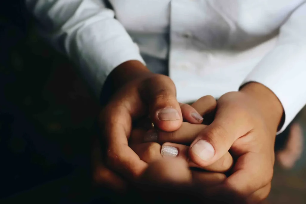 A man holding a woman's hands.