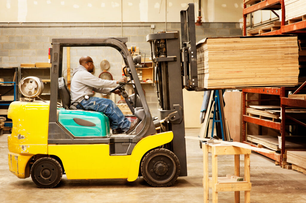 A man driving a forklift.